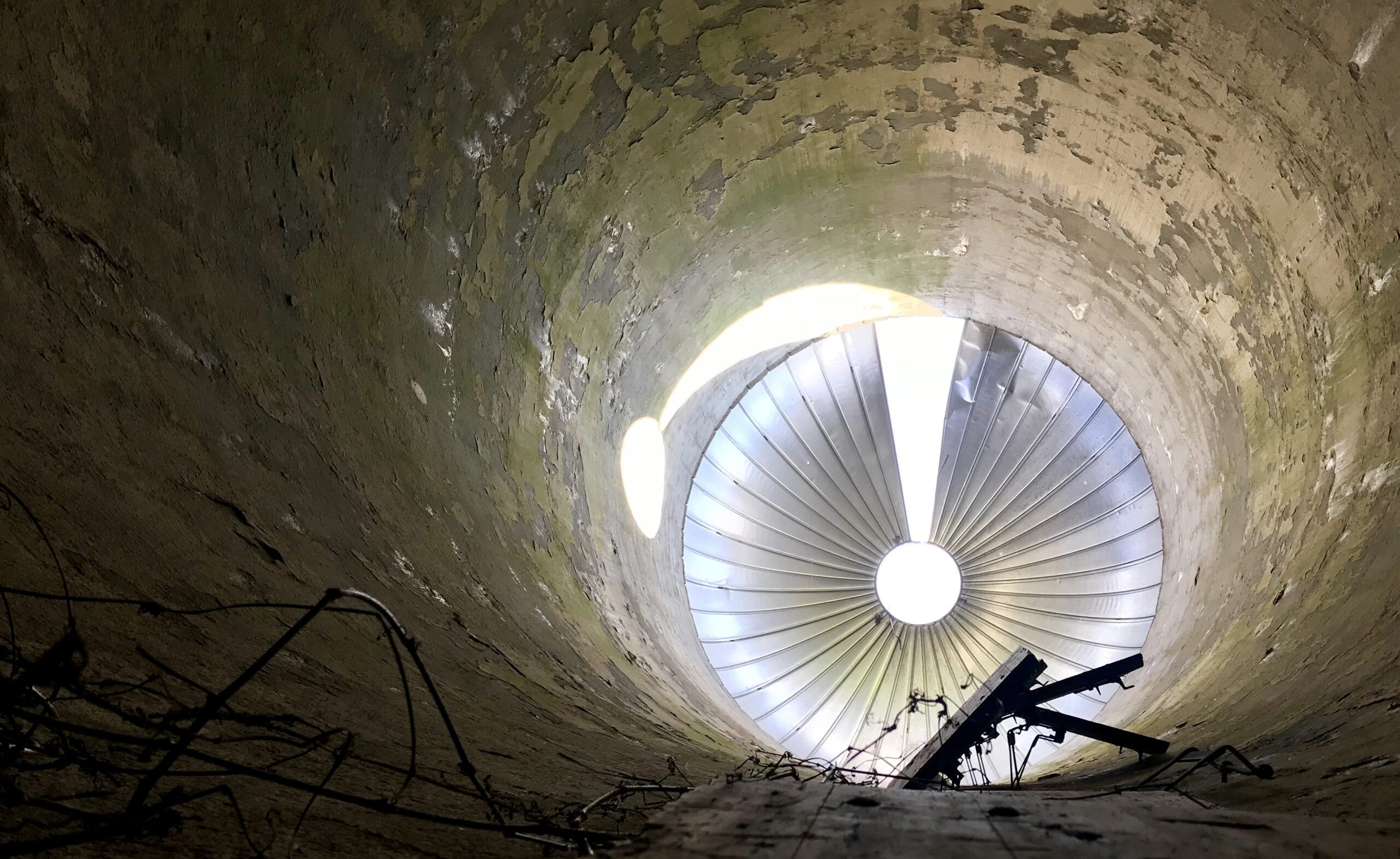 Photograph of the inside of a cement silo shooting through the top