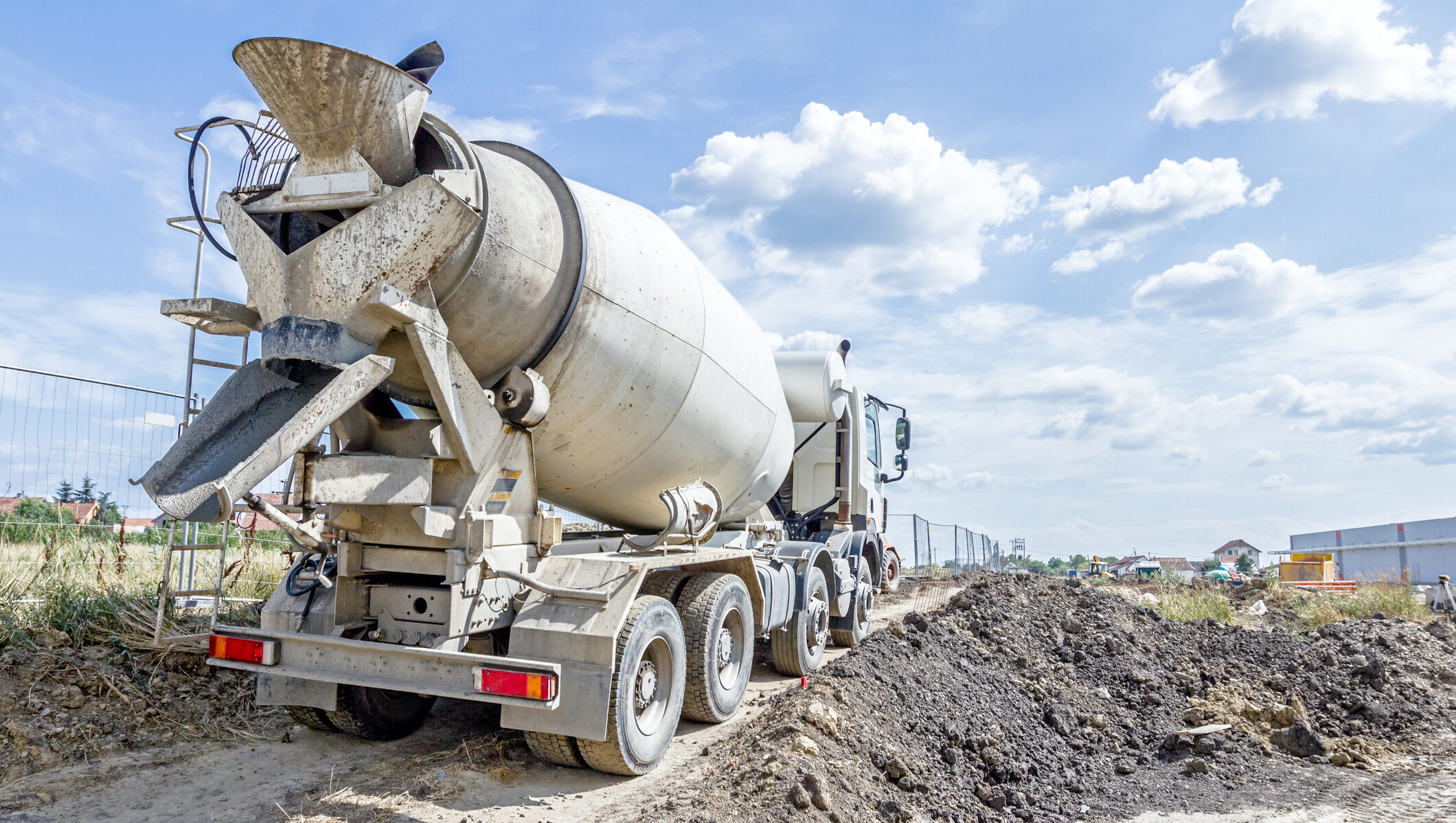 Back side view on concrete mixer, ready for pouring into transporter